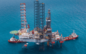 A functioning oil rig in the middle of an ocean.