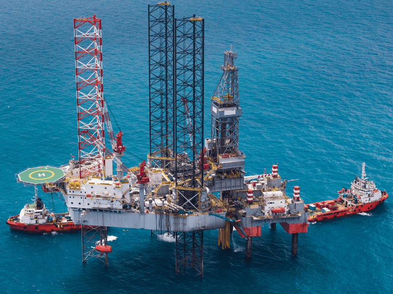A functioning oil rig in the middle of an ocean.