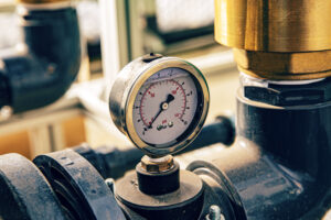 pressure-gauge-on-industrial-pipe-system-close-up